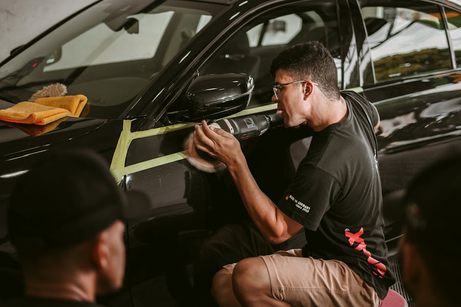 Professional detailer carefully polishing a car exterior
